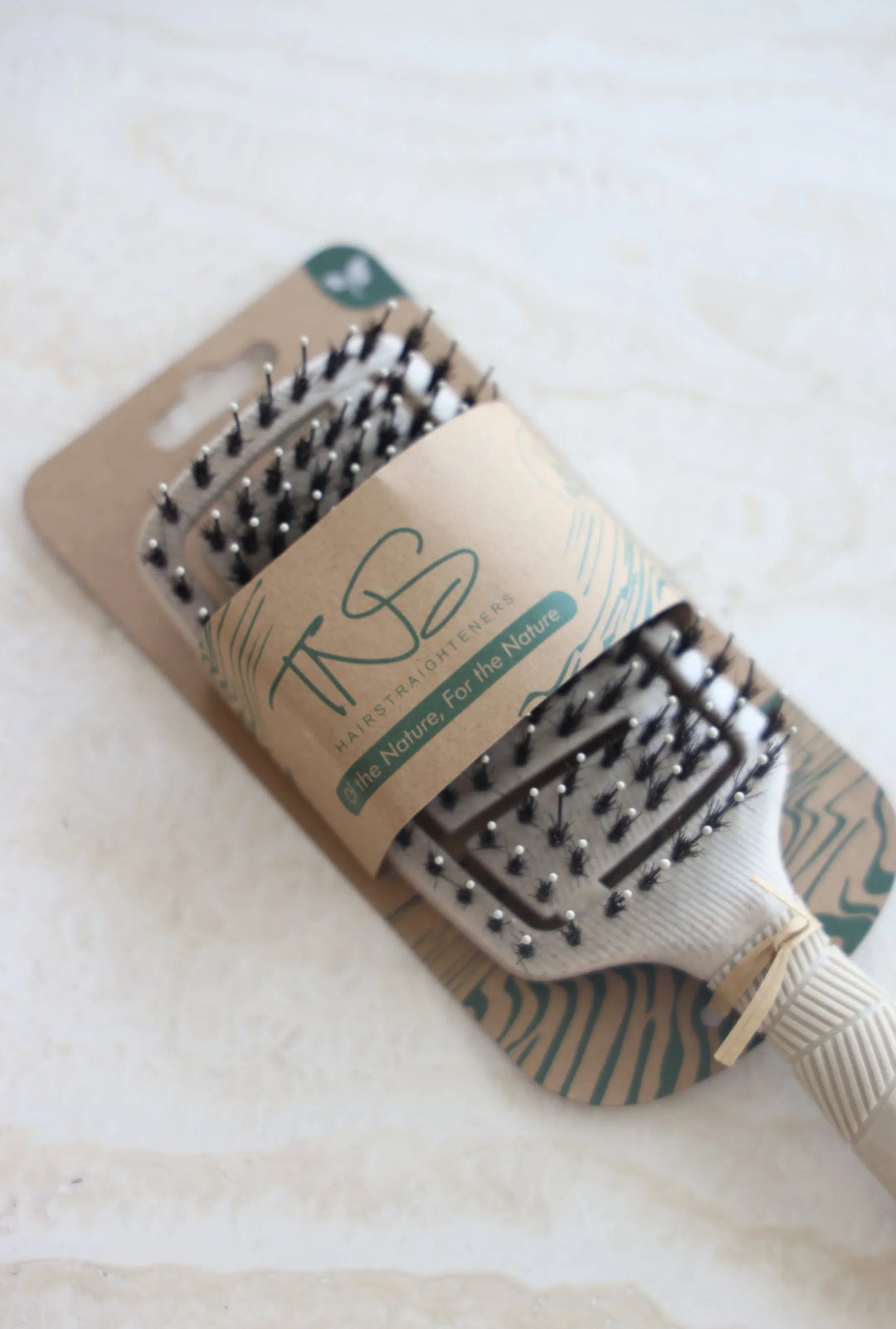 TNS BIO Flexi detangling brush in recyclable kraft packaging