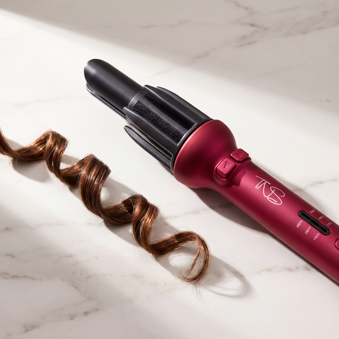 TNS Auto Curler on a marble vanity with glossy curls