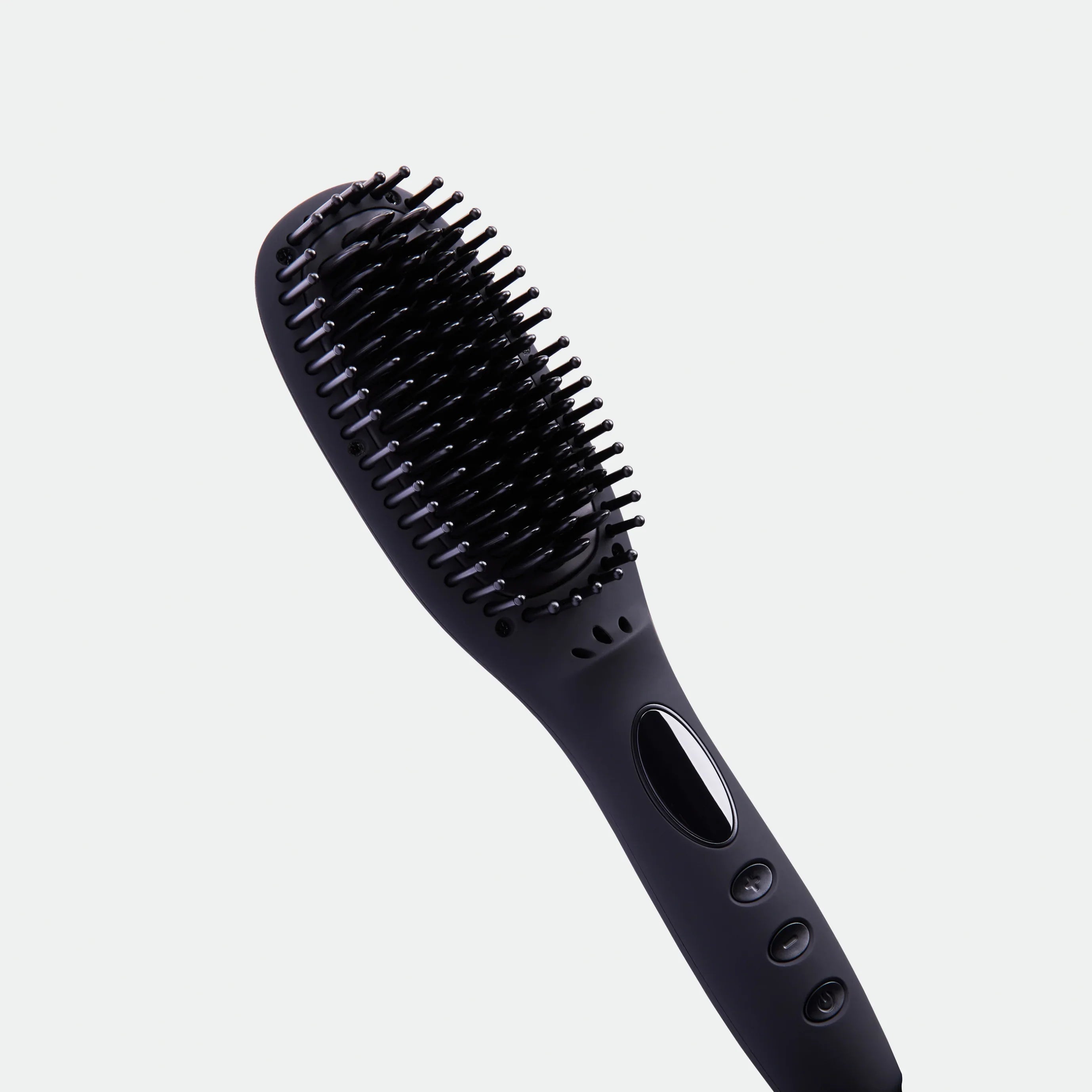 TNS Straightening Brush in Black, angled close-up of the heated bristles and vented body