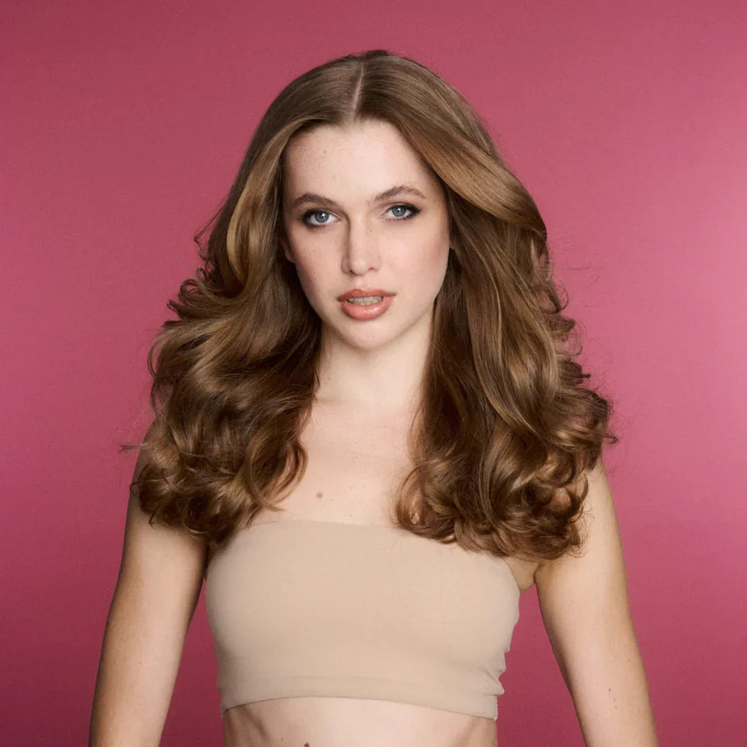 Soft bouncy spring curls against a pink studio backdrop