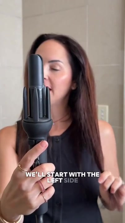 The TNS Auto Curler held up close, the automatic curler our buying guide covers