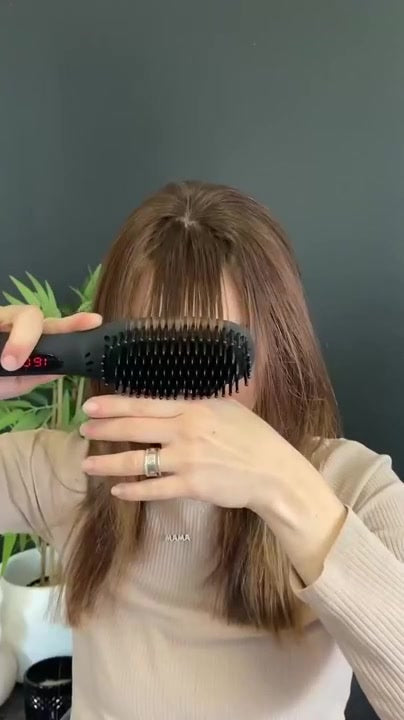 The final pass of a straightening brush routine, hair sleek and smooth