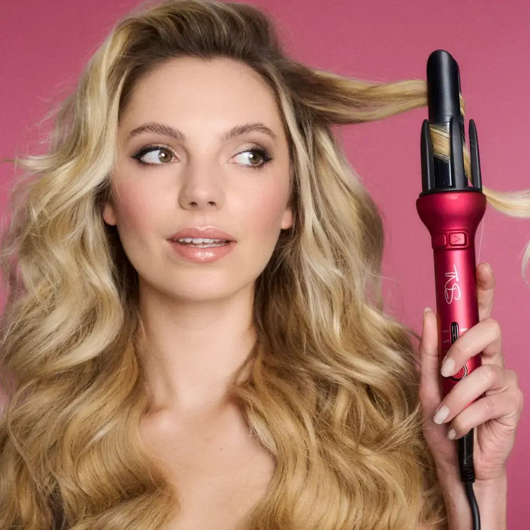 Woman holding the maroon TNS Auto Curler, an automatic hair curler